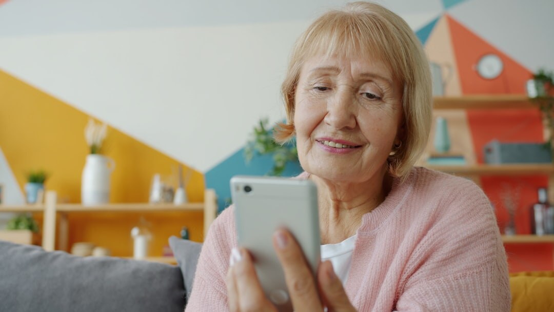 Friendly Slovak senior woman talking on a video call at home