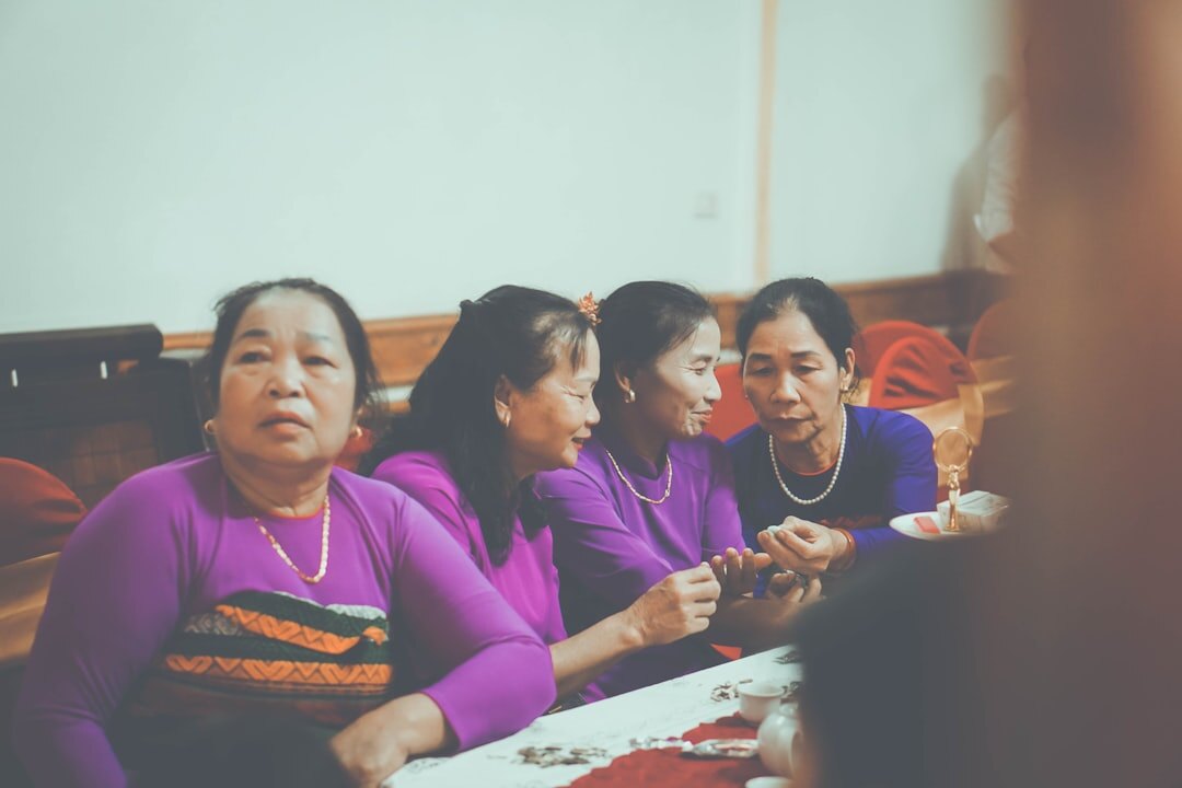 Slovak seniors sharing a meal and conversation at a long community table