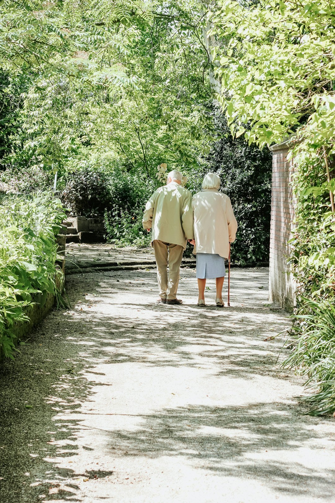 Group of active Slovak seniors laughing and walking together in a sunny park